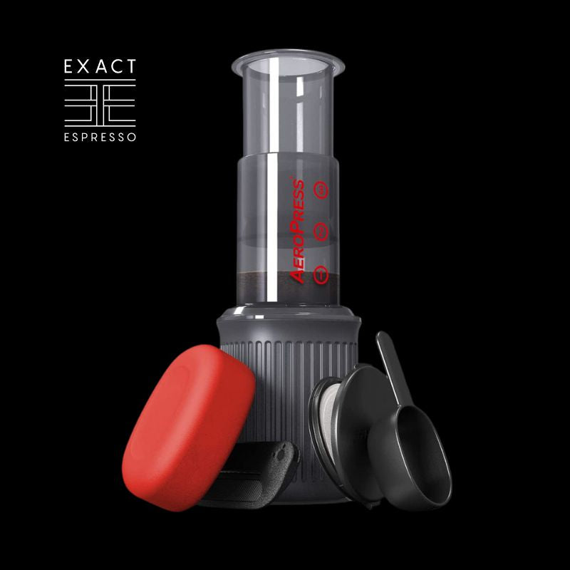 AeroPress Go coffee maker with red travel case and brewing accessories on black background.
