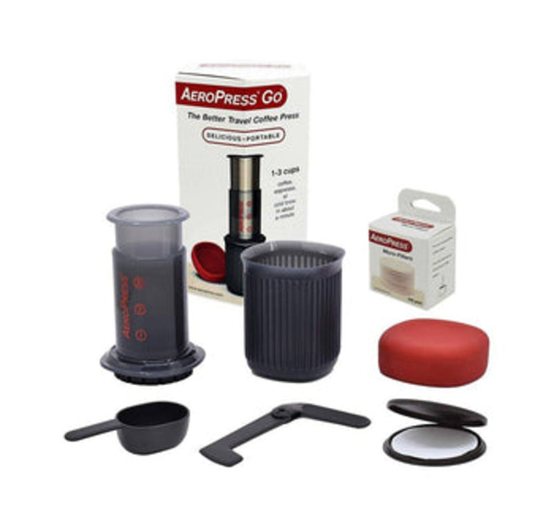 Complete AeroPress Go kit next to product box and filter pack, arranged for display