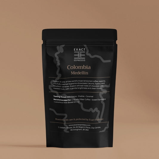 Premium black coffee packaging featuring "Colombia Medellin" label and product details on a warm beige background.