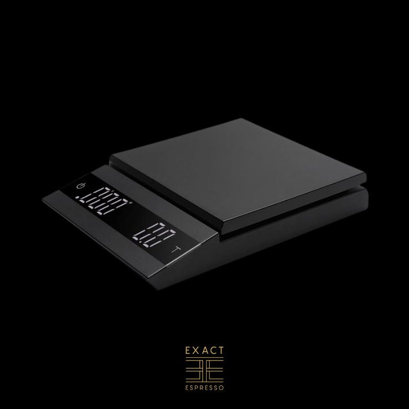 A digital coffee scale with a matte black finish and dual LED display on a black background.