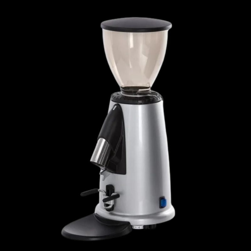 Silver Fracino F2 On Demand coffee grinder with black lid, bean hopper, and stainless steel dispensing spout, set against a black background.