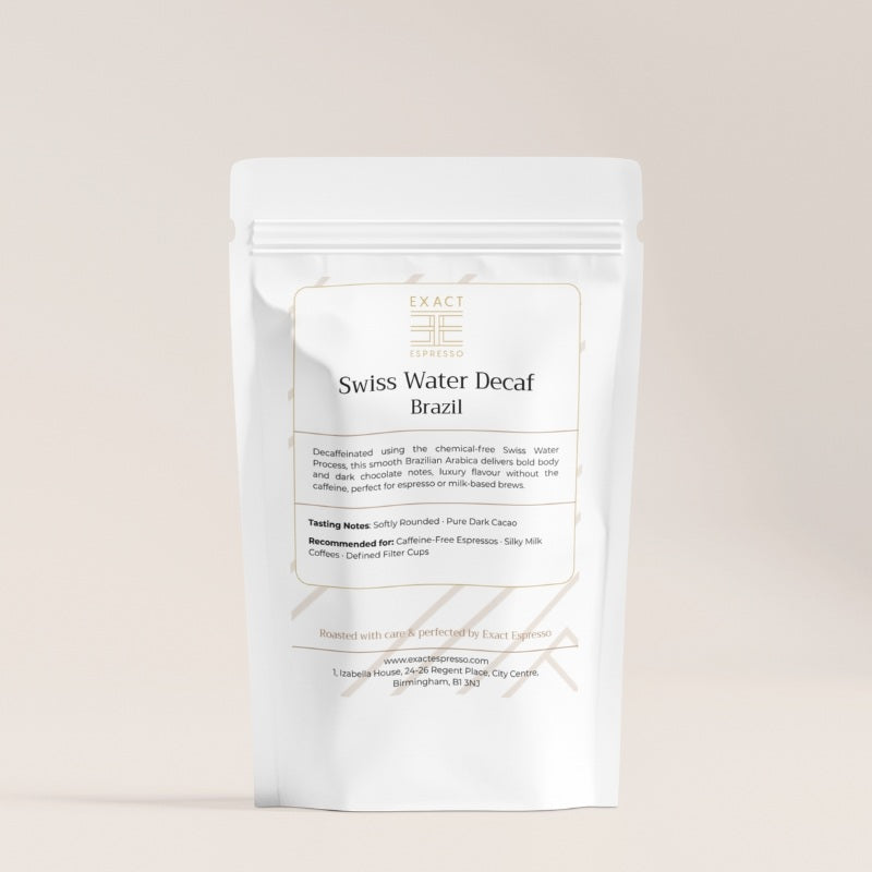 Swiss Water Decaf Brazil coffee bag by Exact Espresso shown on a beige background with soft lighting.
