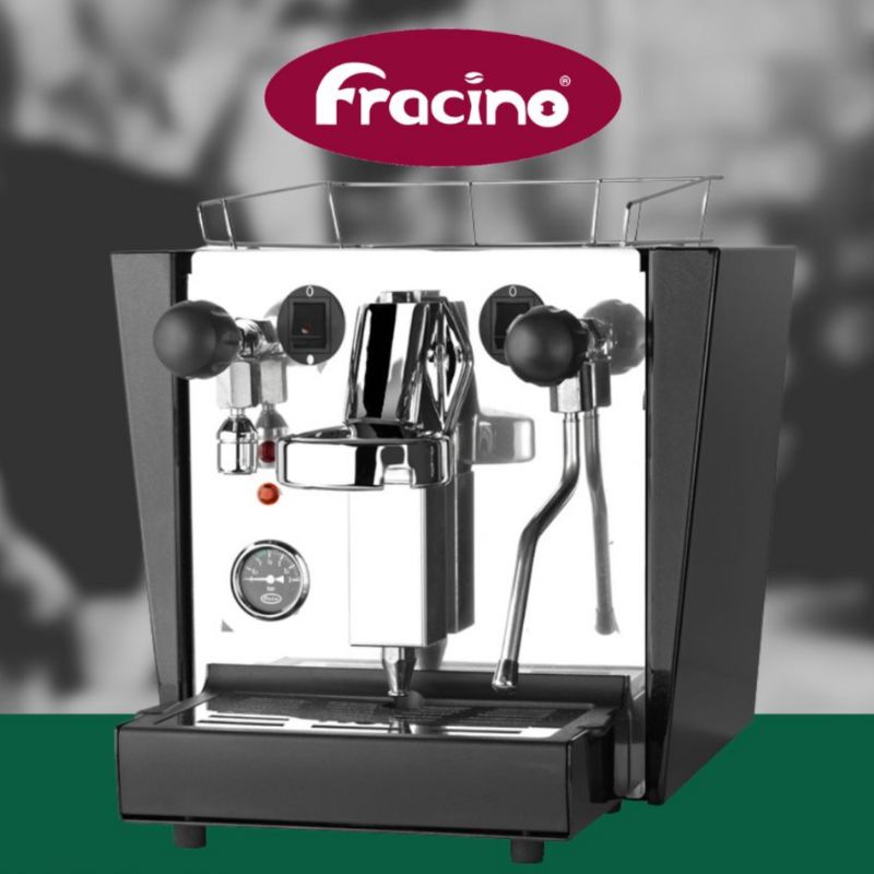 Fracino Cherub coffee machine with branding and blurred café background