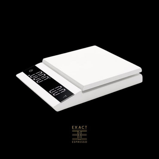 A white digital coffee scale with a dual LED display against a black background.A white digital coffee scale with a dual LED display against a black background.