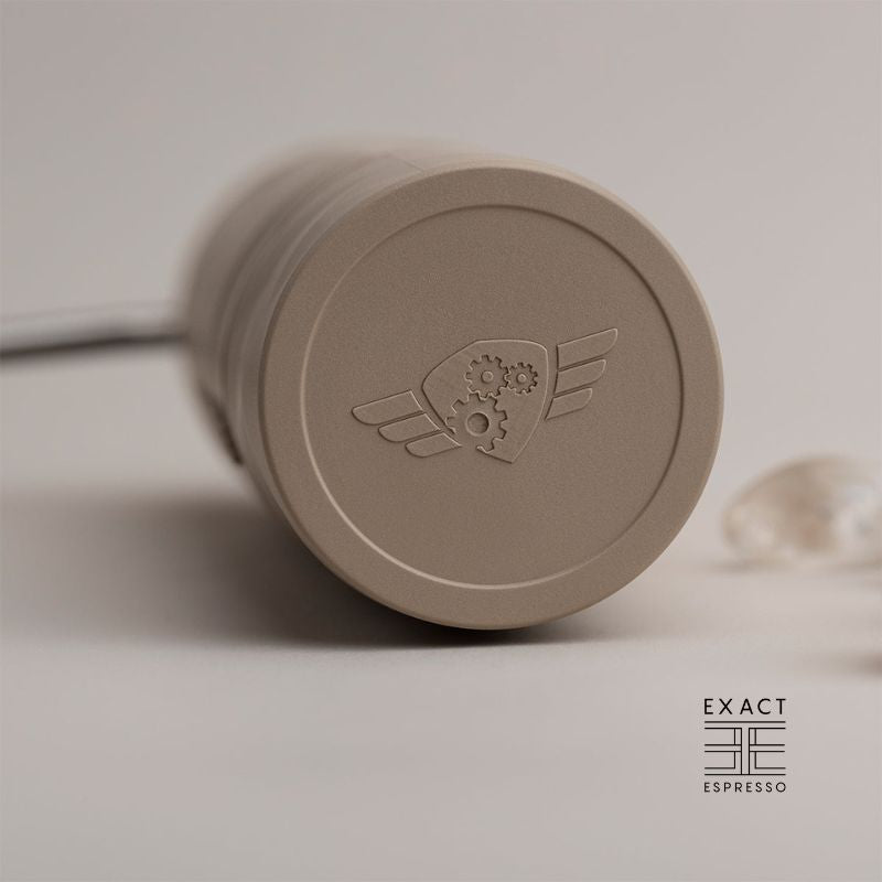 Close-up of Comandante X25 grinder base showing embossed logo.