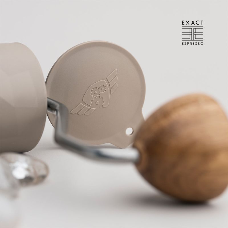Side view of the wooden knob and logoed lid of the Comandante grinder.